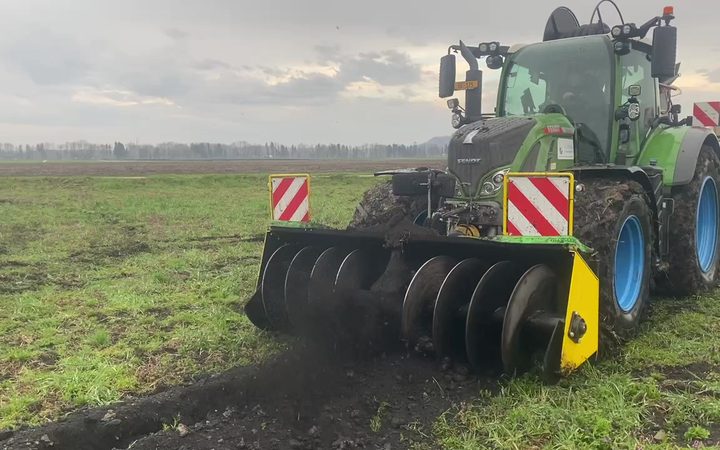 Graben-Verfüllschnecke am Traktor auf dem Acker